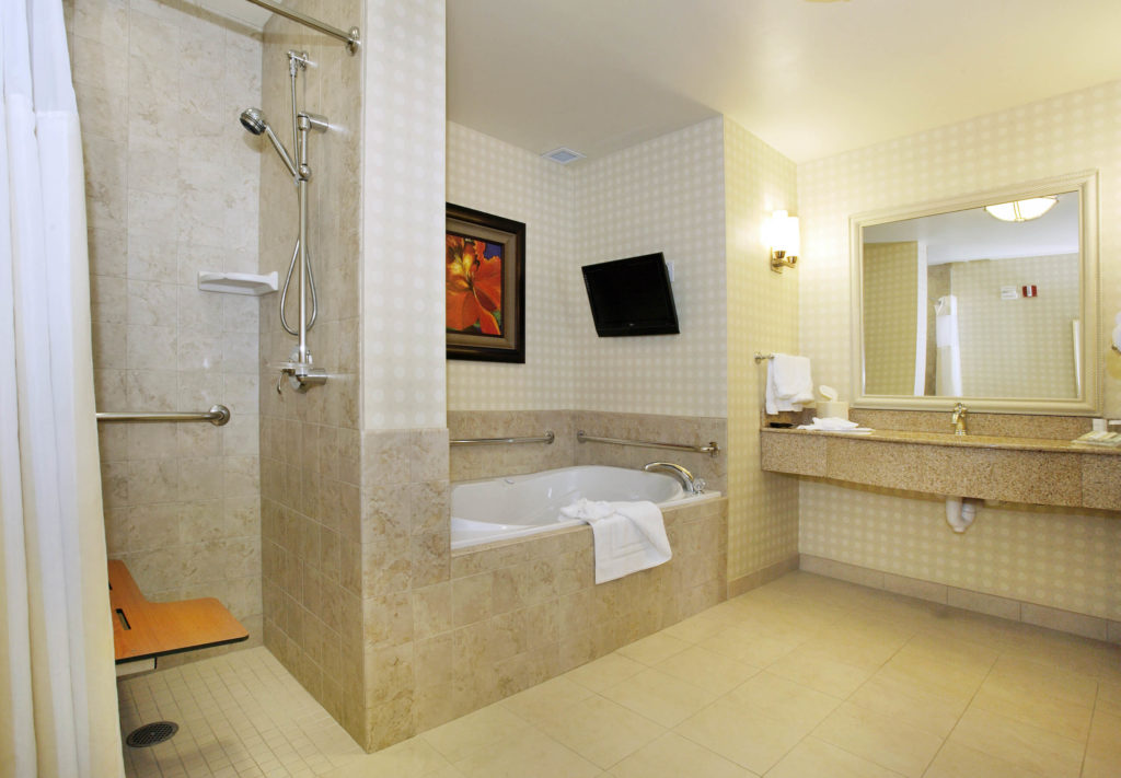 Bathroom with bars in shower and bathtub